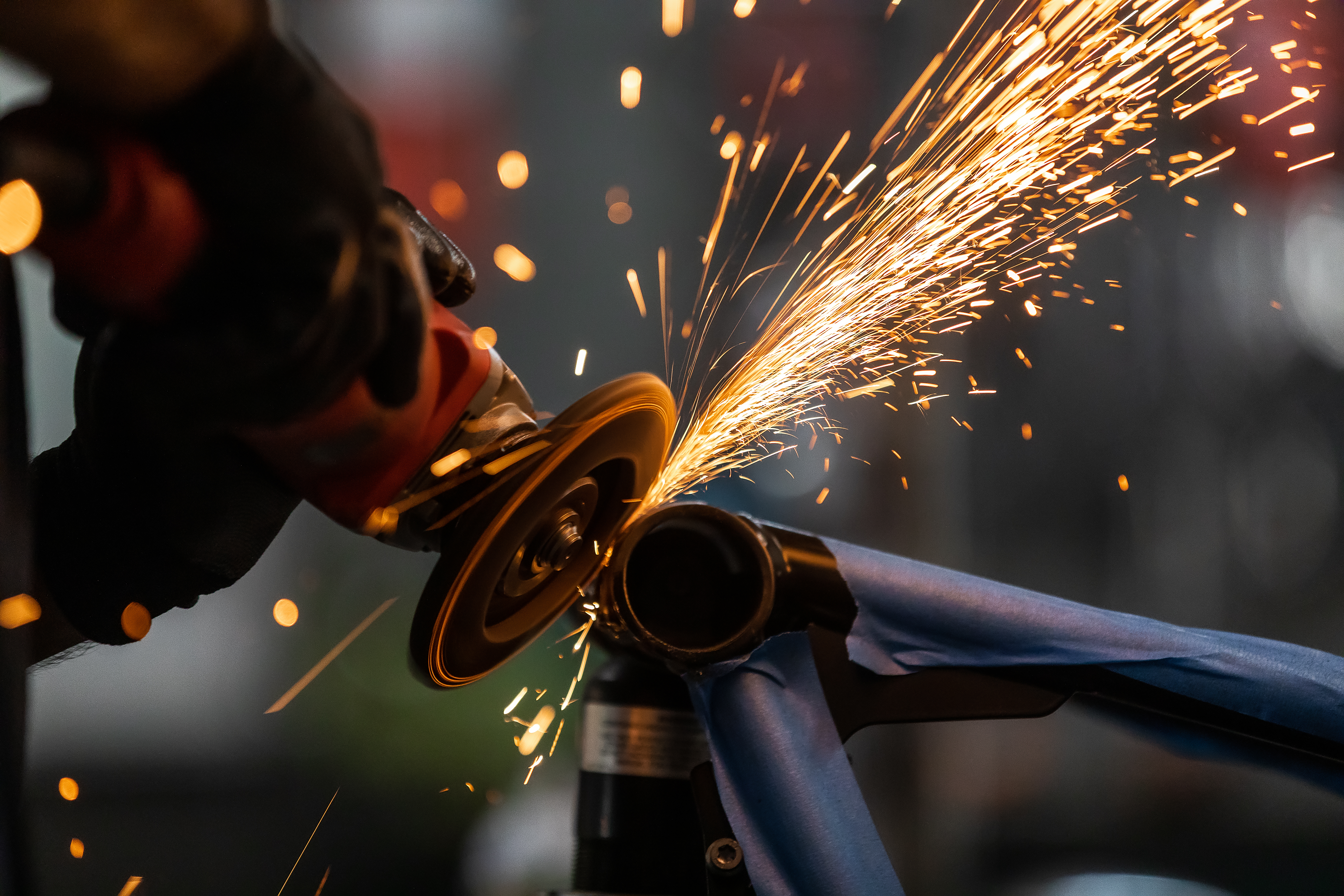 About Us Image of a man grinding steel.